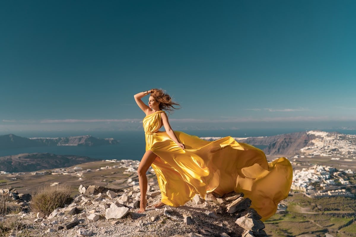 Flying dress photoshoot on a morning near Pyrgos village, Santorini