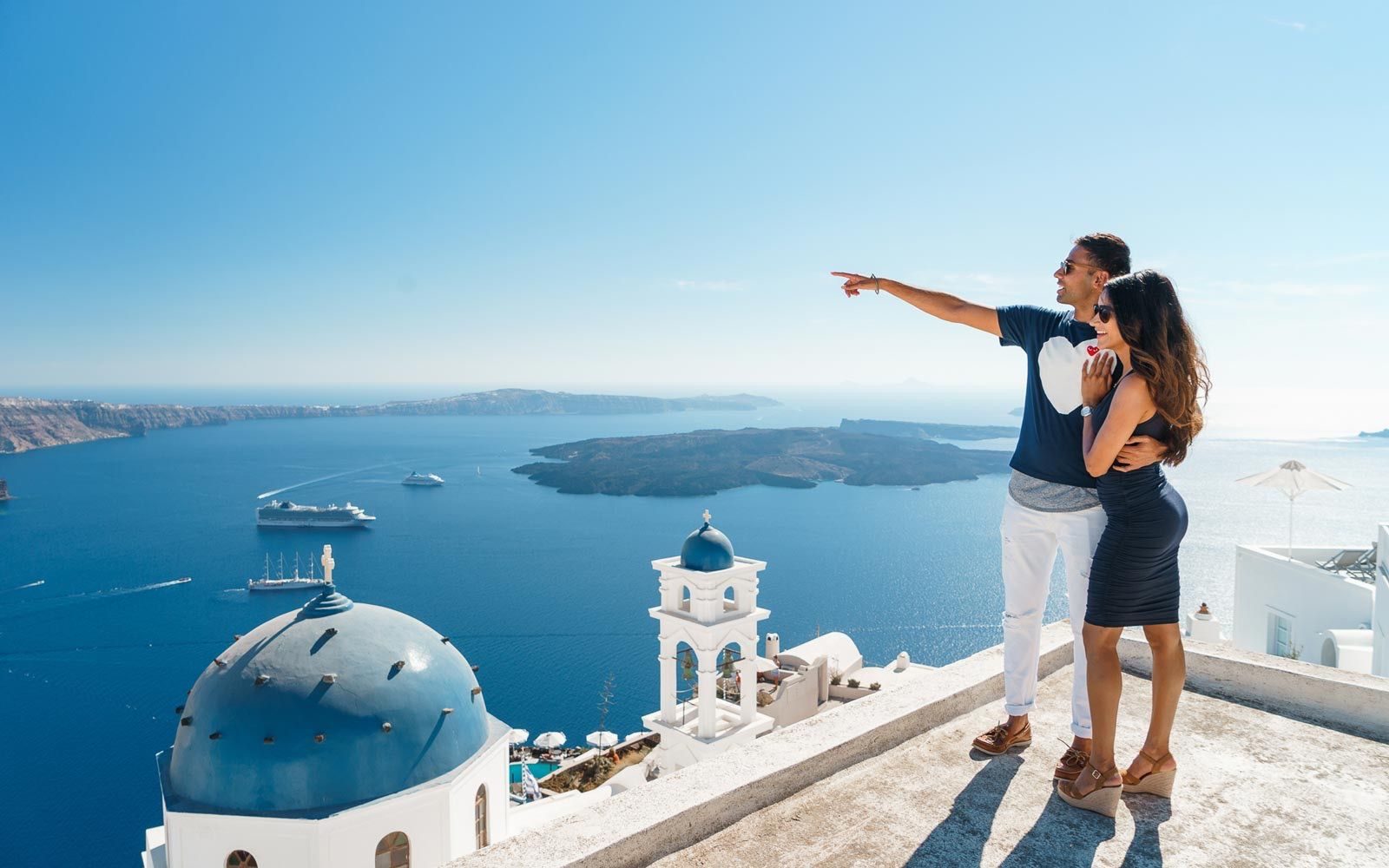 Couple watching the view in Imerovigli village