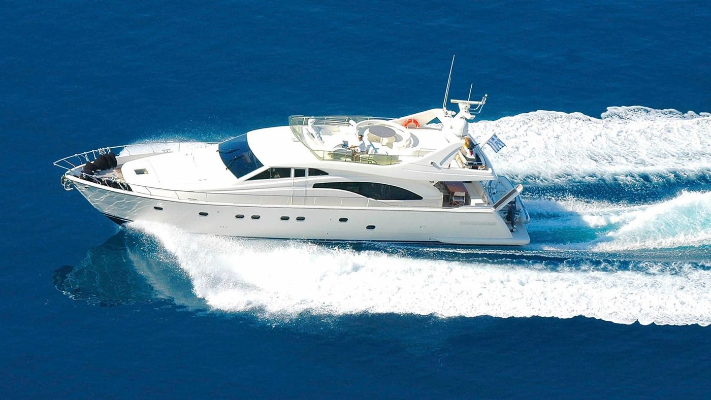 White luxury motor yacht cruising at speed on deep blue sea