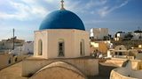 Blue-domed church above the rooftops of Megalochori