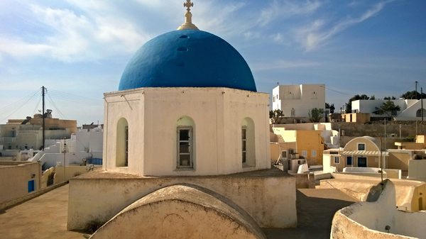 Blue-domed church above the rooftops of Megalochori