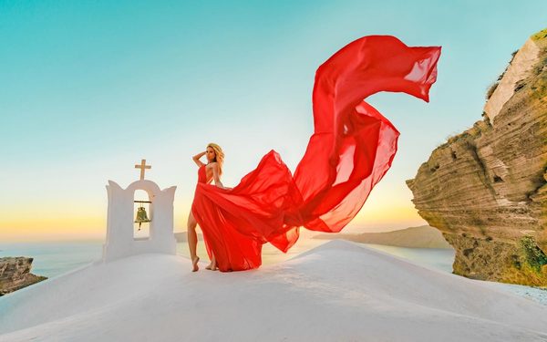 Photo shoot on Santorini with a red flying dress